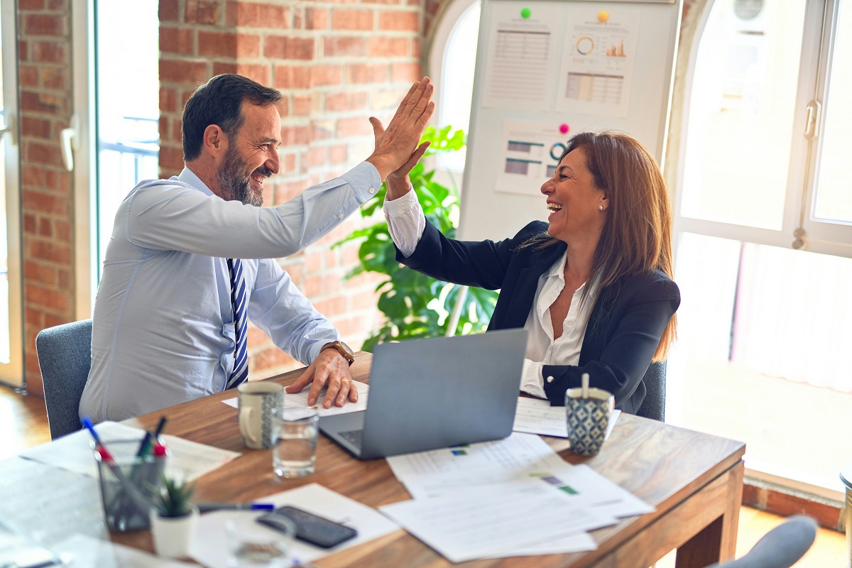 business professionals giving each other high fives